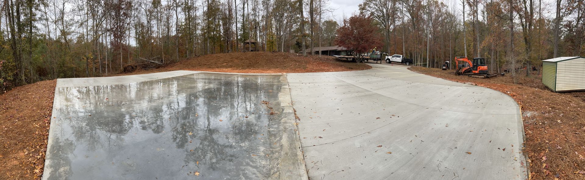 A large concrete slab is sitting in the middle of a dirt road.