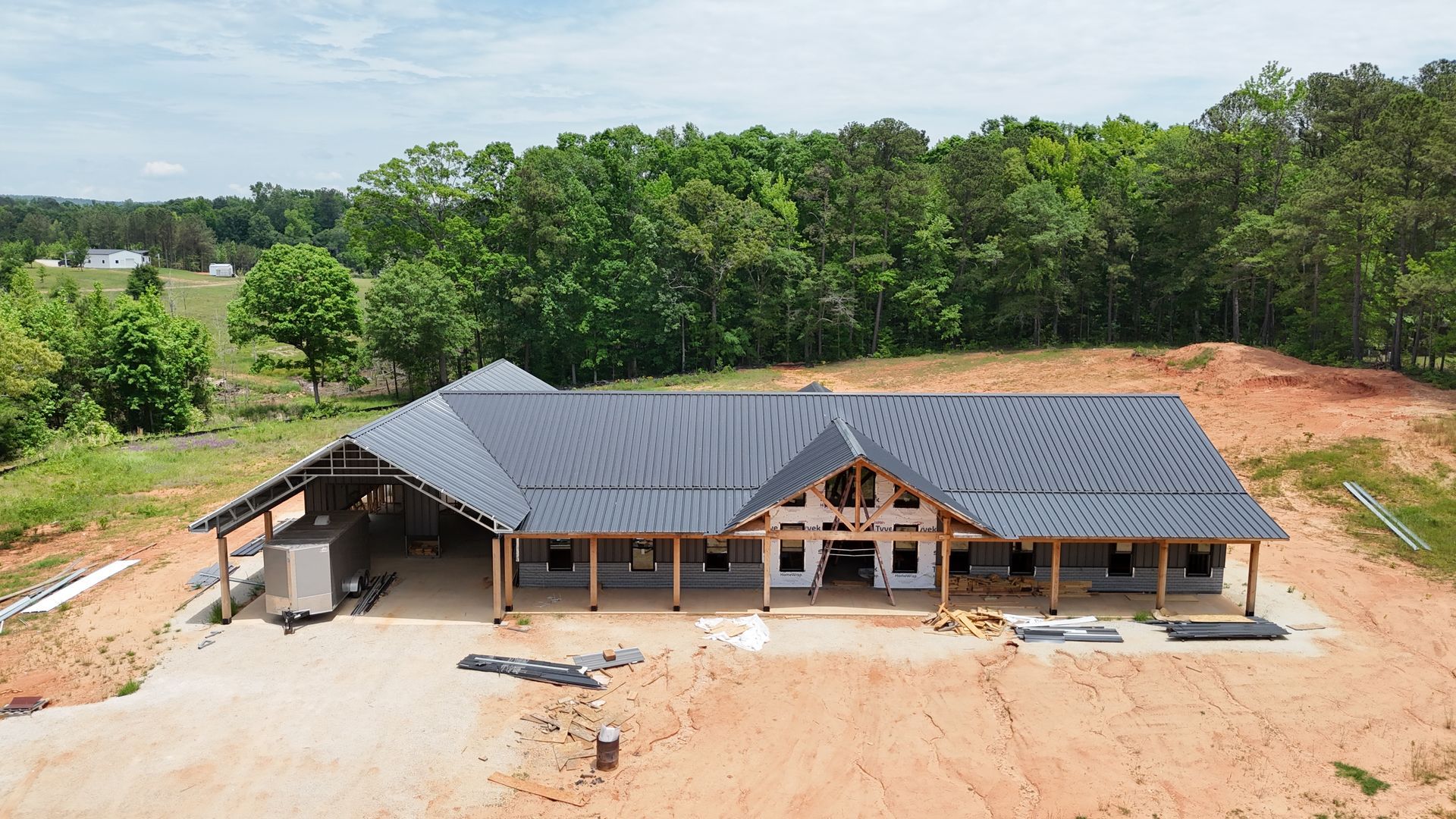 An aerial view of a house under construction in the middle of a field.