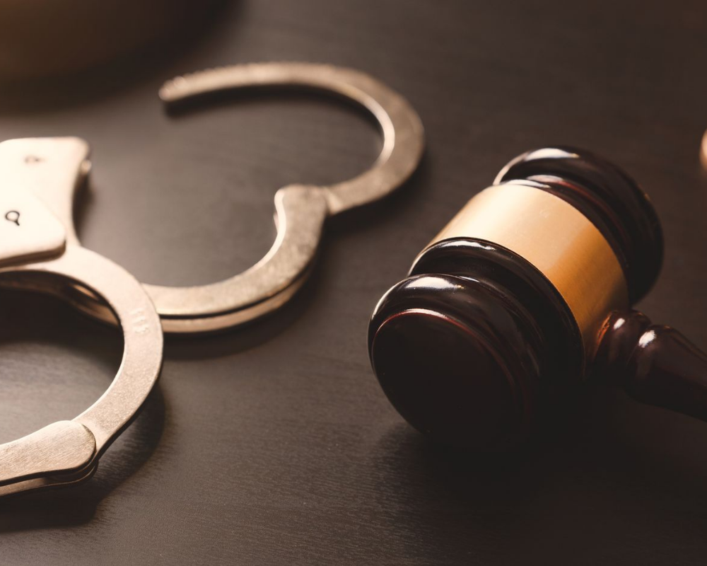 A Pair Of Handcuffs And A Judge 's Gavel On A Table — Kingsport, TN — Francisco & Harr