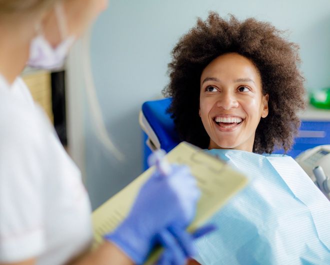 Afro Woman Talking To Dentist — Waynesboro, GA — Burke Co. Dental