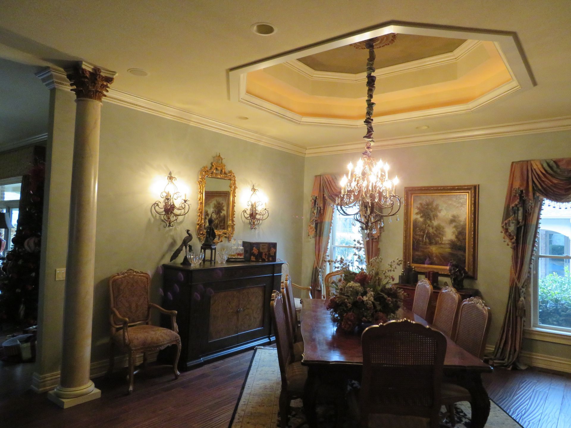 A dining room with a table and chairs and a chandelier