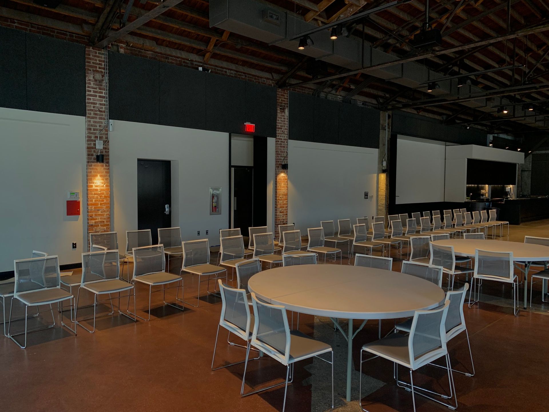 A large room with tables and chairs in it