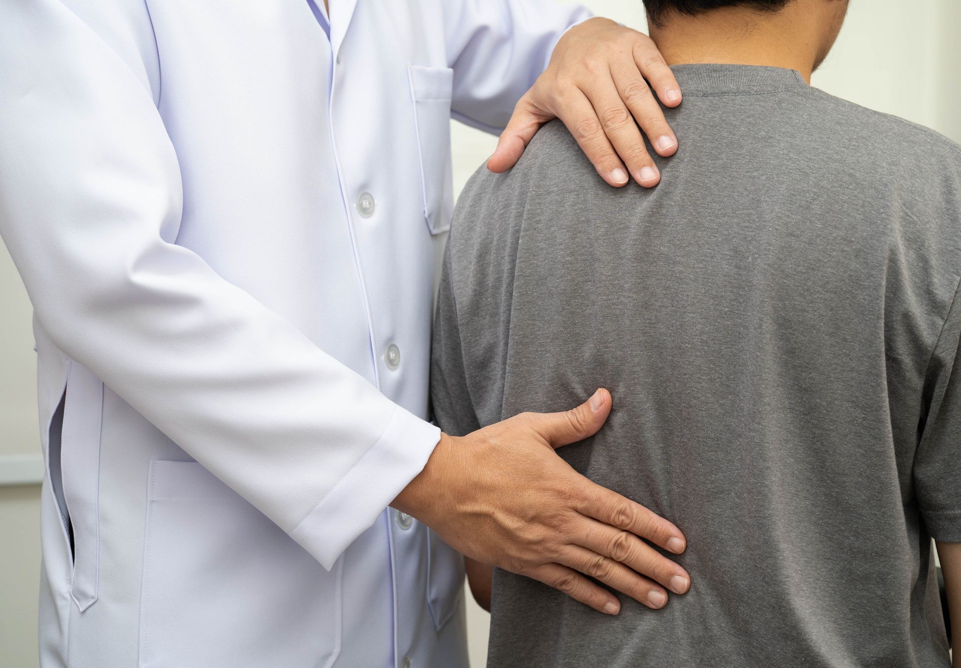 The chiropractor treats a young man's pain in the hospital.
