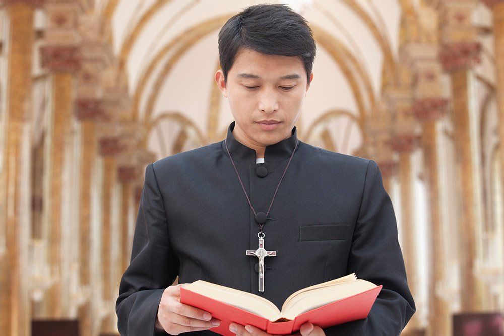 Priest Holding A Bible Book — Saint John, IN — Boric Religious Gift
