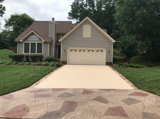 “Wide concrete driveway leading to a suburban home and garage by a concrete contractor in Casas Adobes, AZ”