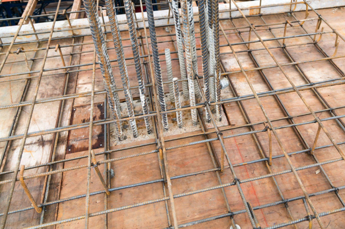 “Steel rebar framework laid out for a concrete wall foundation before pouring by a concrete contractor in Casas Adobes, AZ”