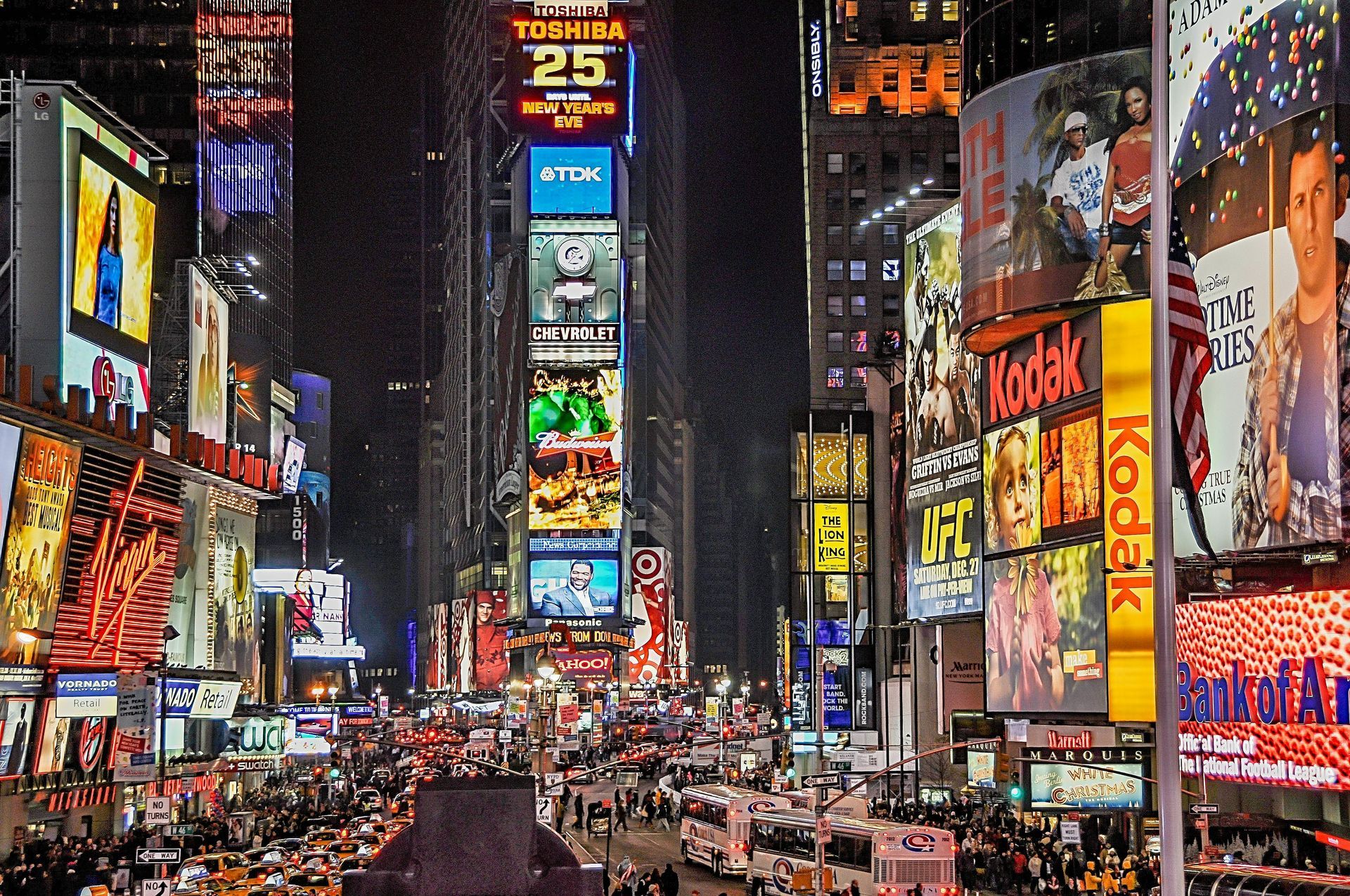 A busy city street with a kodak sign in the middle