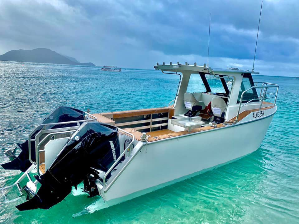 A white boat is floating on top of a body of water.