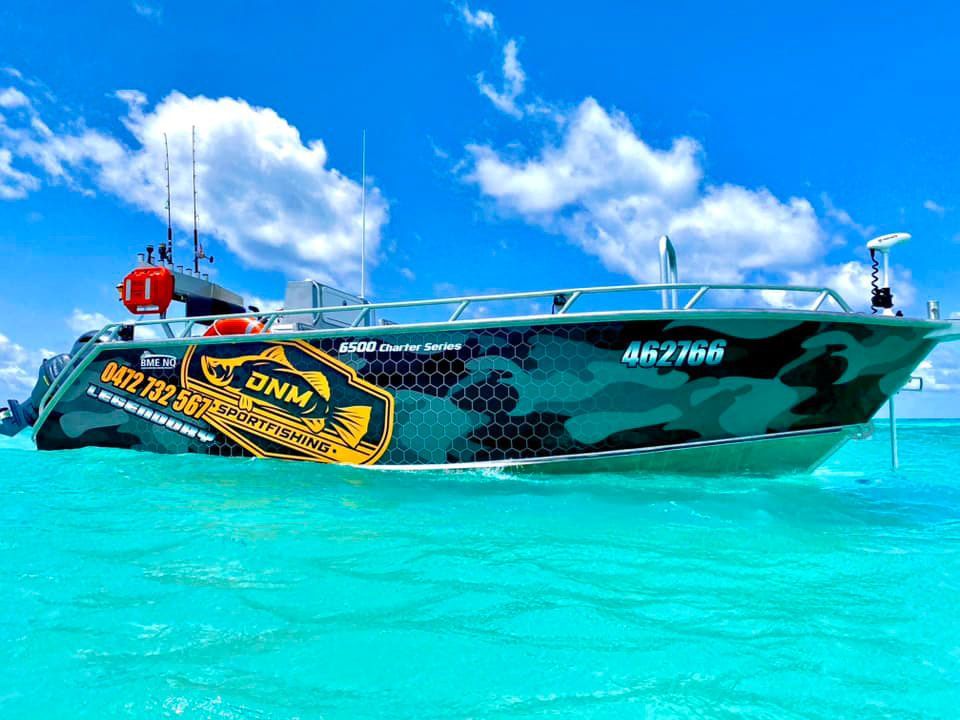 A boat is floating on top of a body of water.