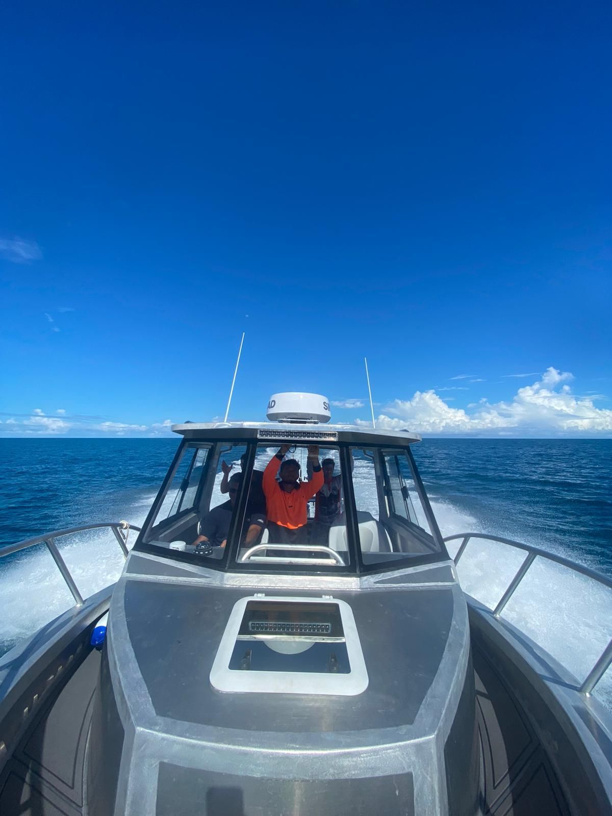 A boat is floating on top of a large body of water.