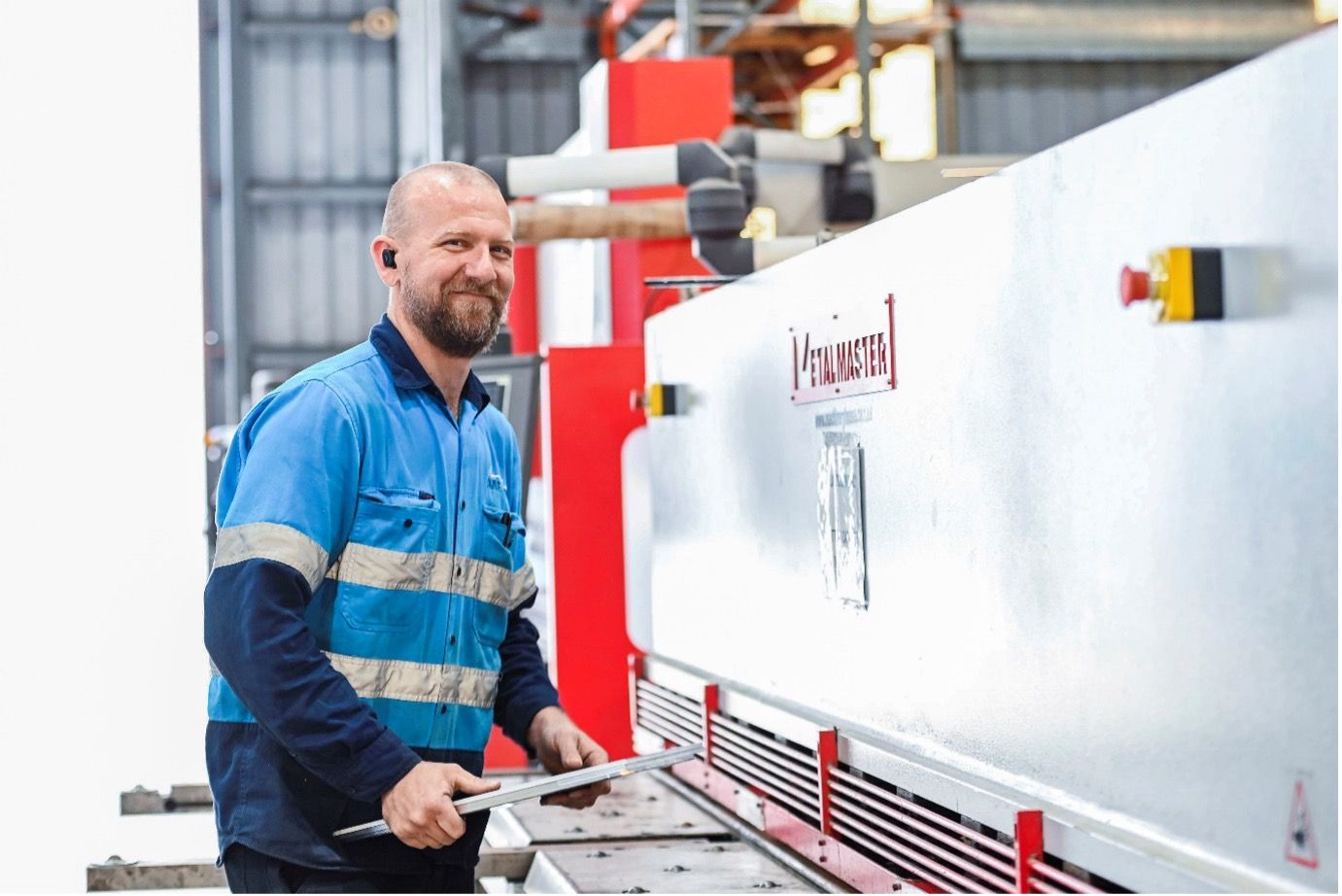 A man is working on a machine in a factory.