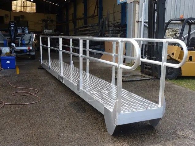 A forklift is parked behind a metal ramp