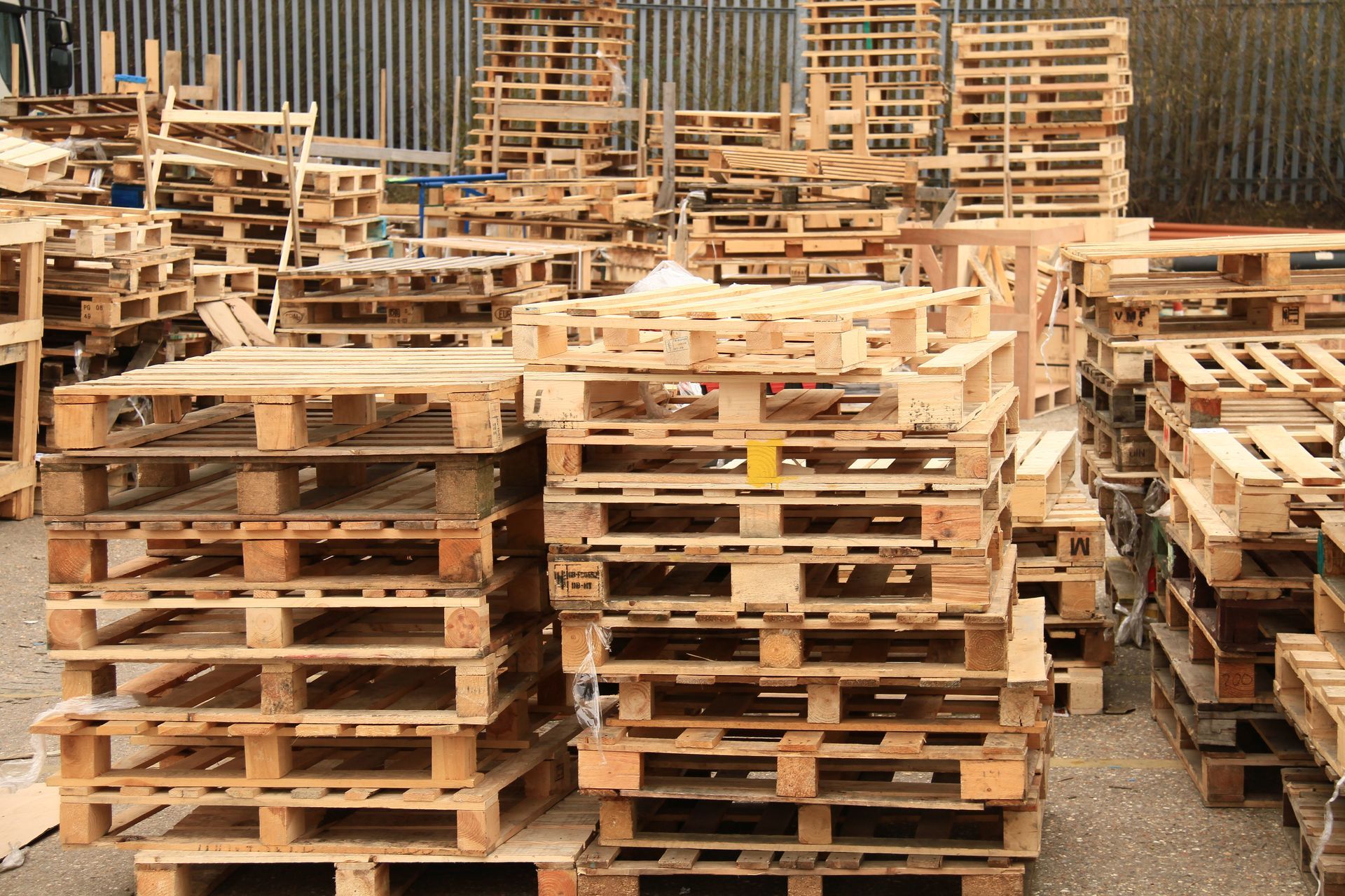 A warehouse filled with lots of wooden pallets on shelves