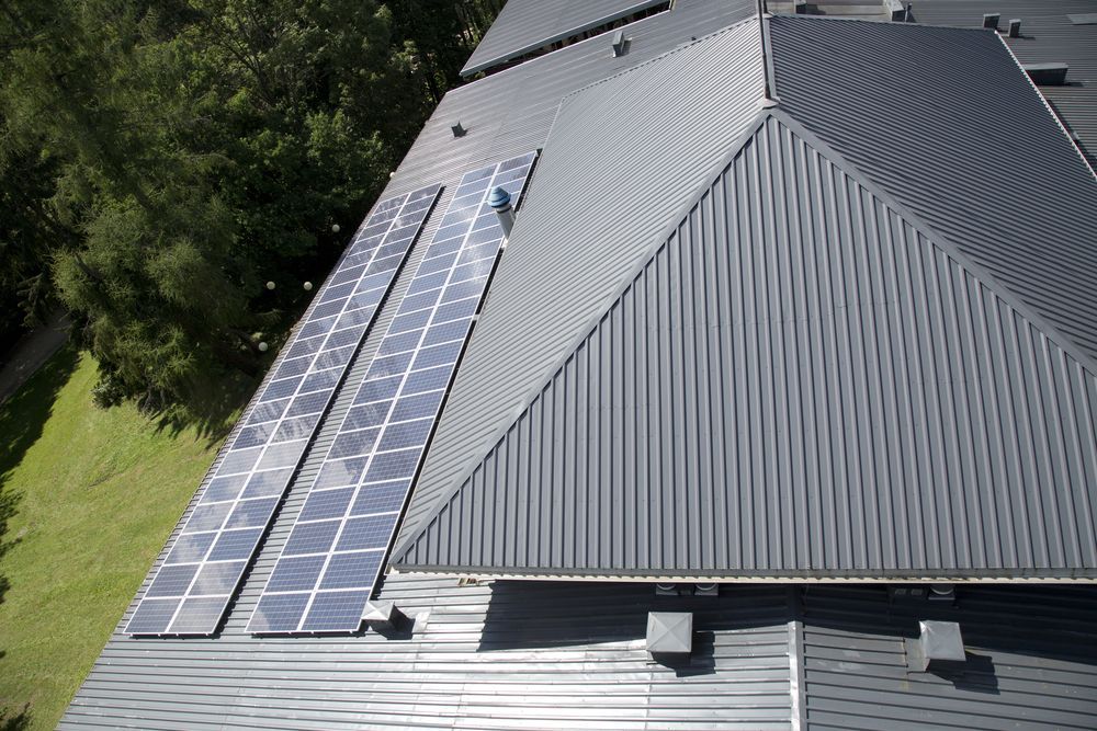 An aerial view of a roof with solar panels on it.
