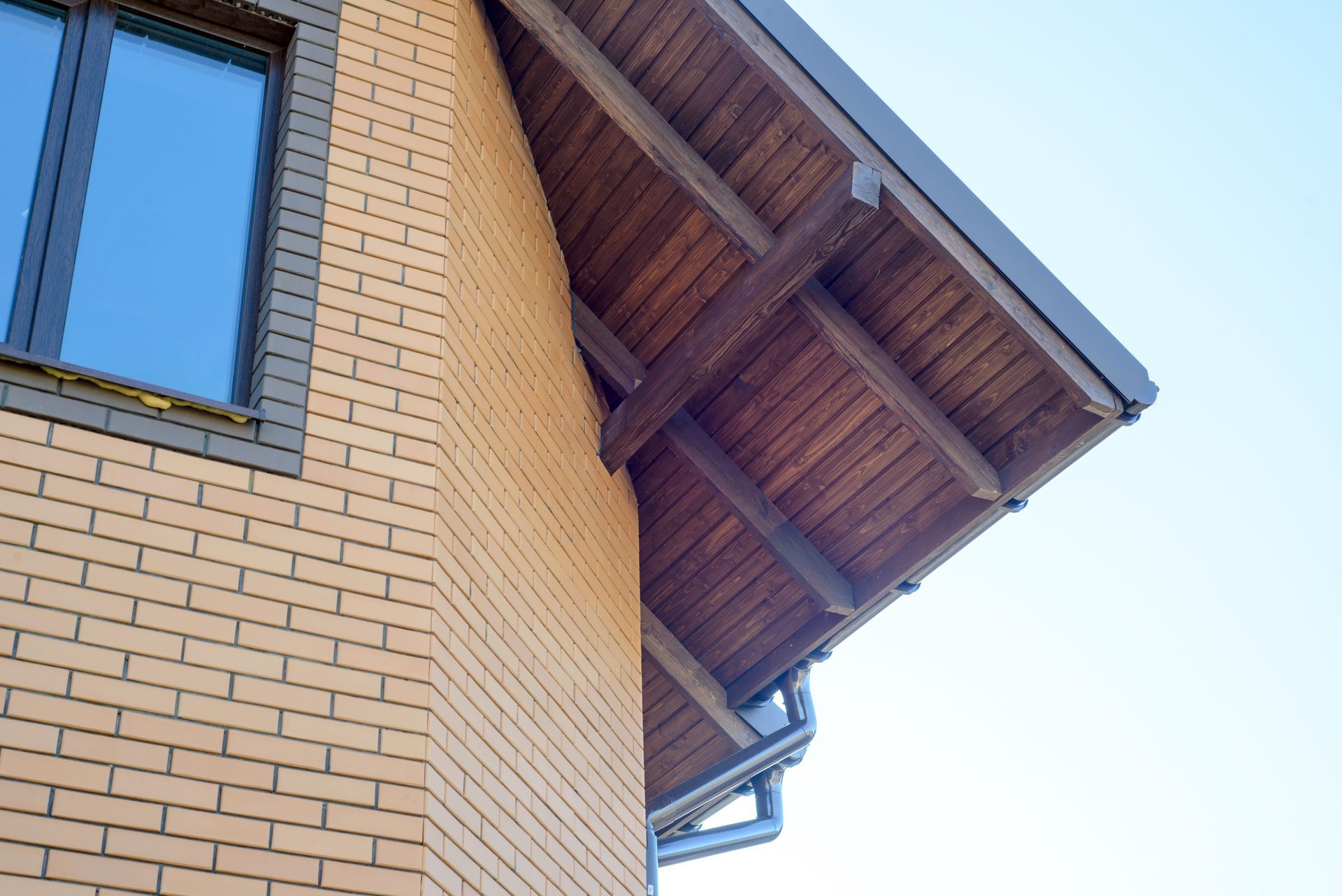 A brick building with a wooden roof and a window