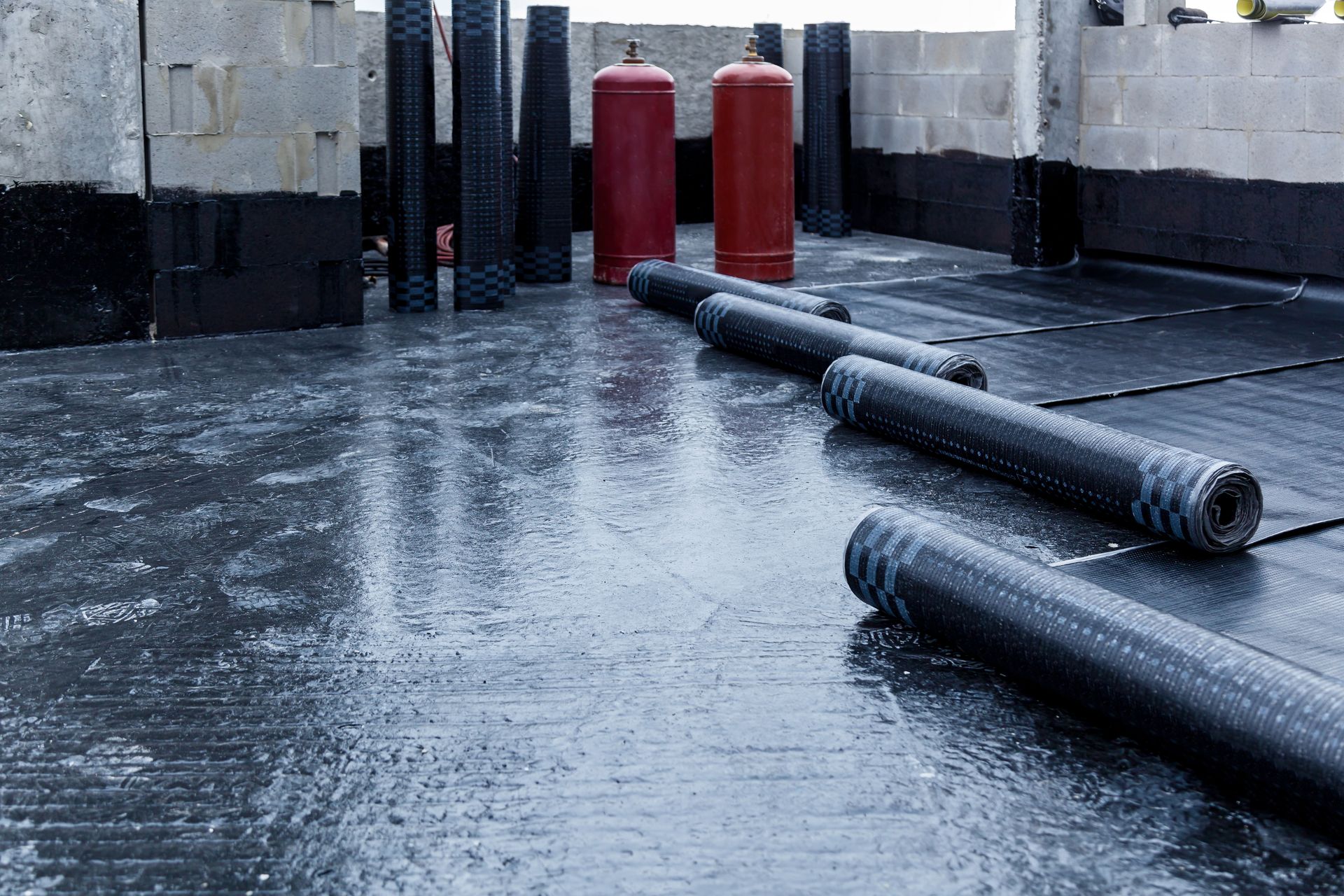 A row of gas cylinders sitting on top of a wet roof.