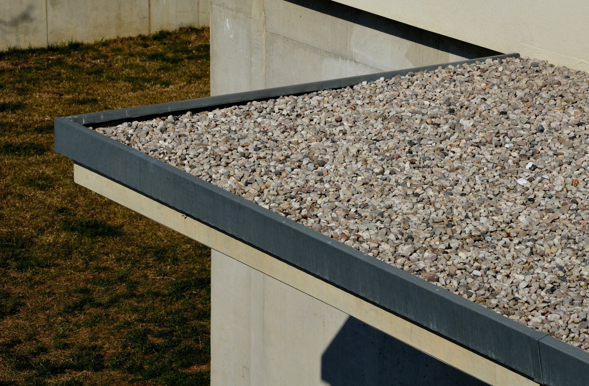 A roof with gravel on it and a black trim
