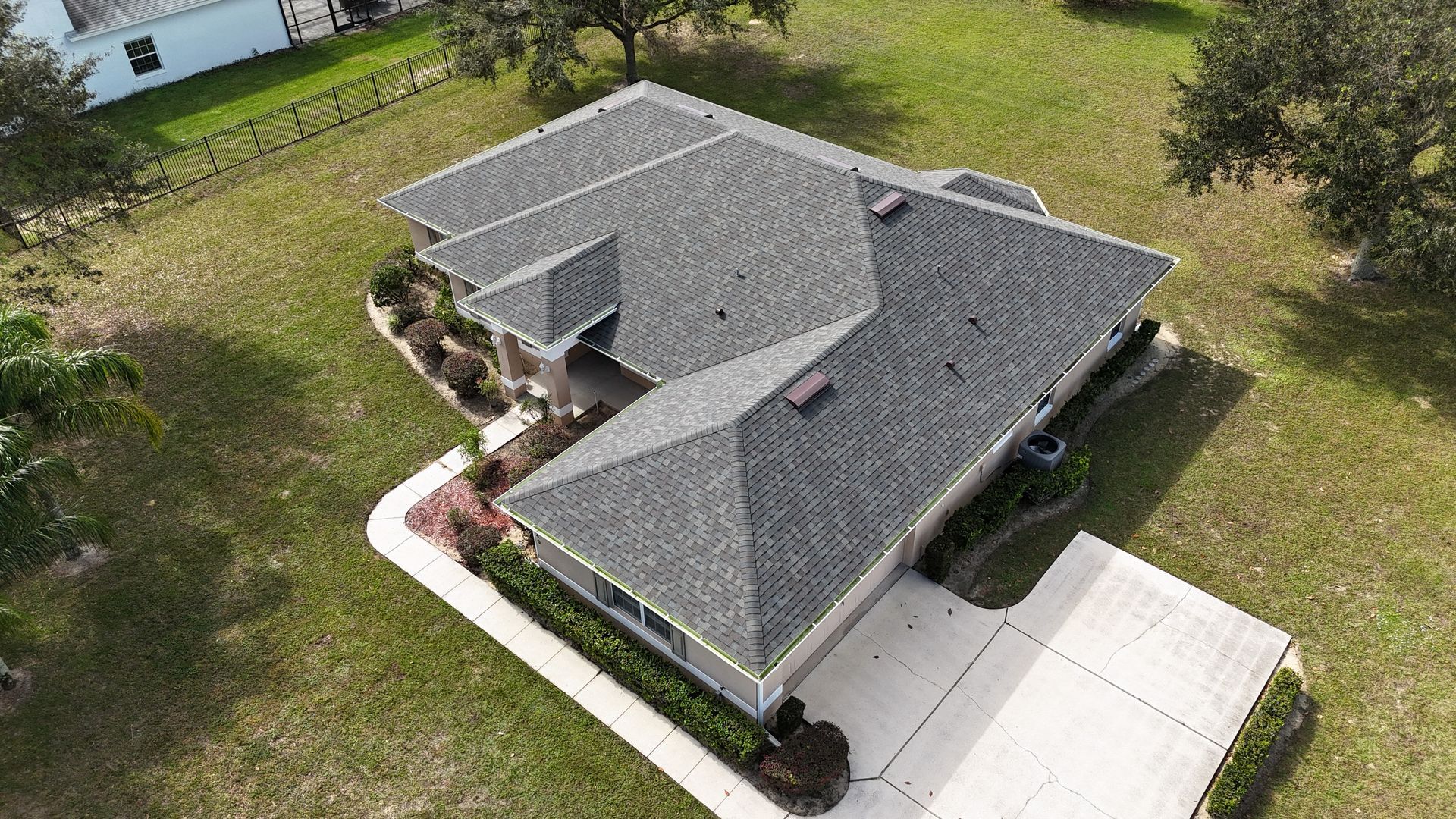 An aerial view of a house with a new roof.
