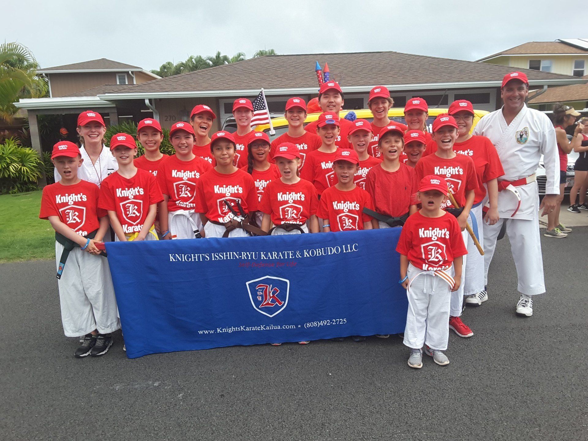 Knight's Karate youth students holding Knight's Karate banner