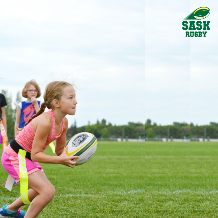 A young person in pink athletic gear runs across a green field holding a rugby ball during a flag rugby match.