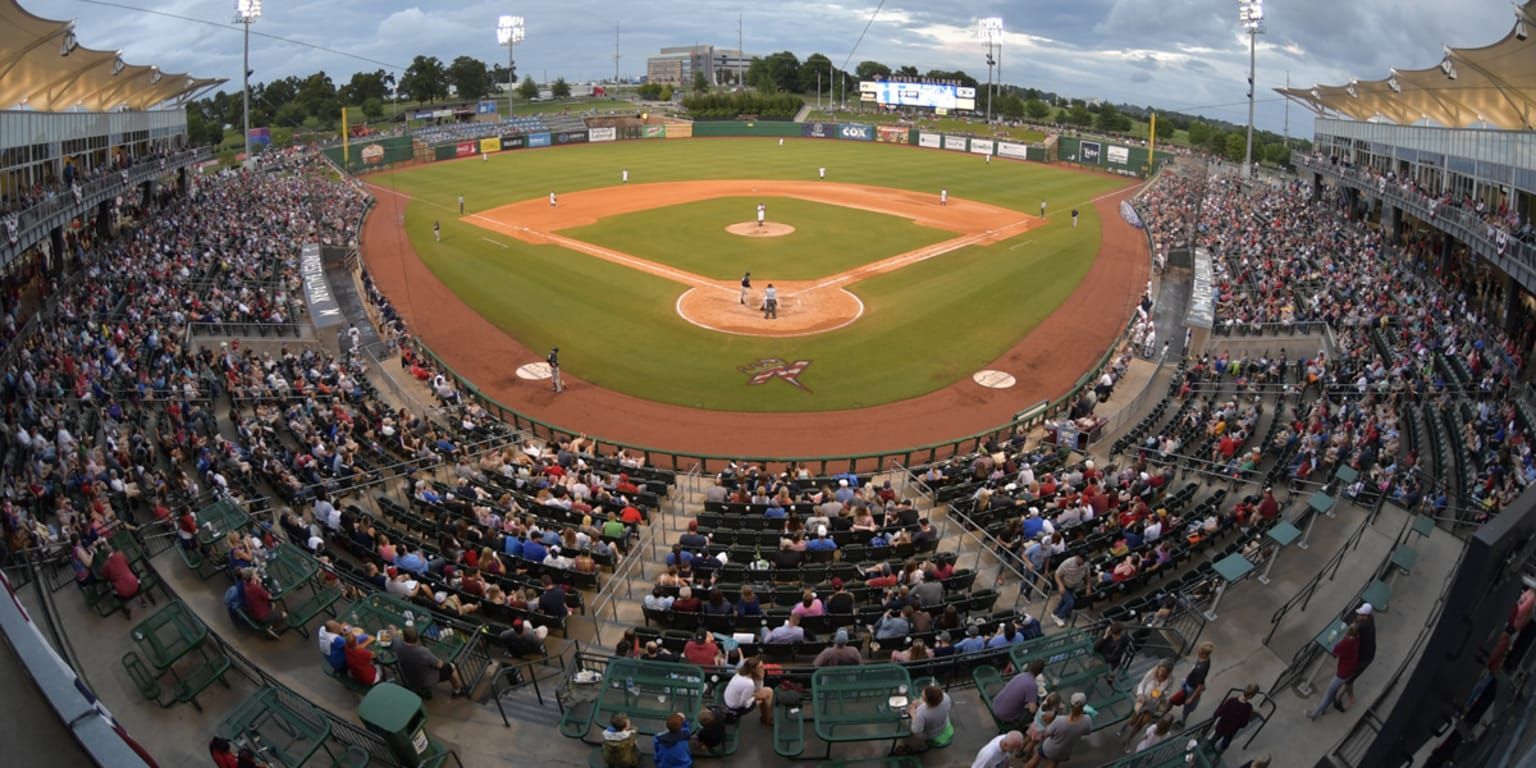 A baseball stadium filled with people watching a game