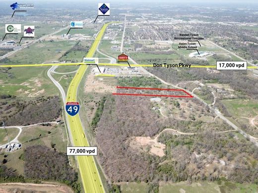 Aerial view of land along I-49 and Don Tyson Parkway, with businesses and traffic visible.