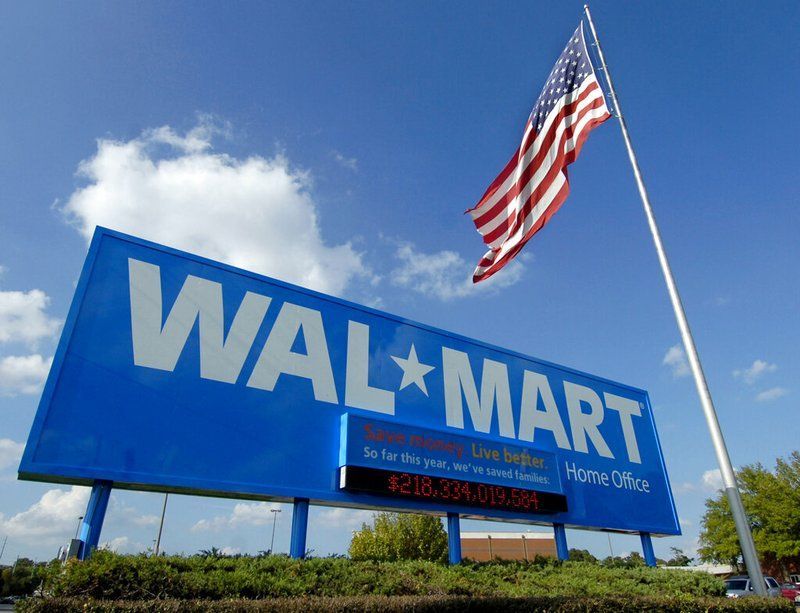 A walmart sign with an american flag in the background