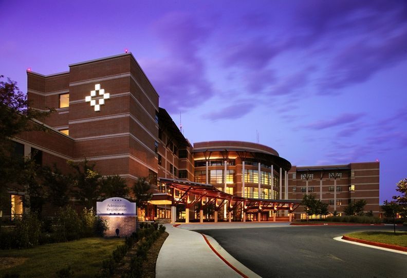 A large brick building with a cross on the side of it