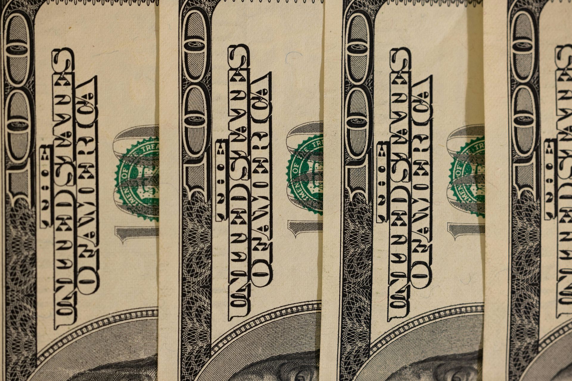 Close-up of several US $100 bills, showing