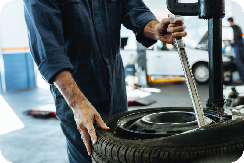 mechanic performing wheel alignment | Surprise Goodyear Car Care