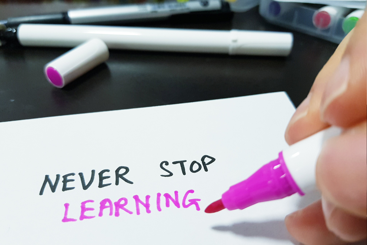 pink marker spelling out never stop learning