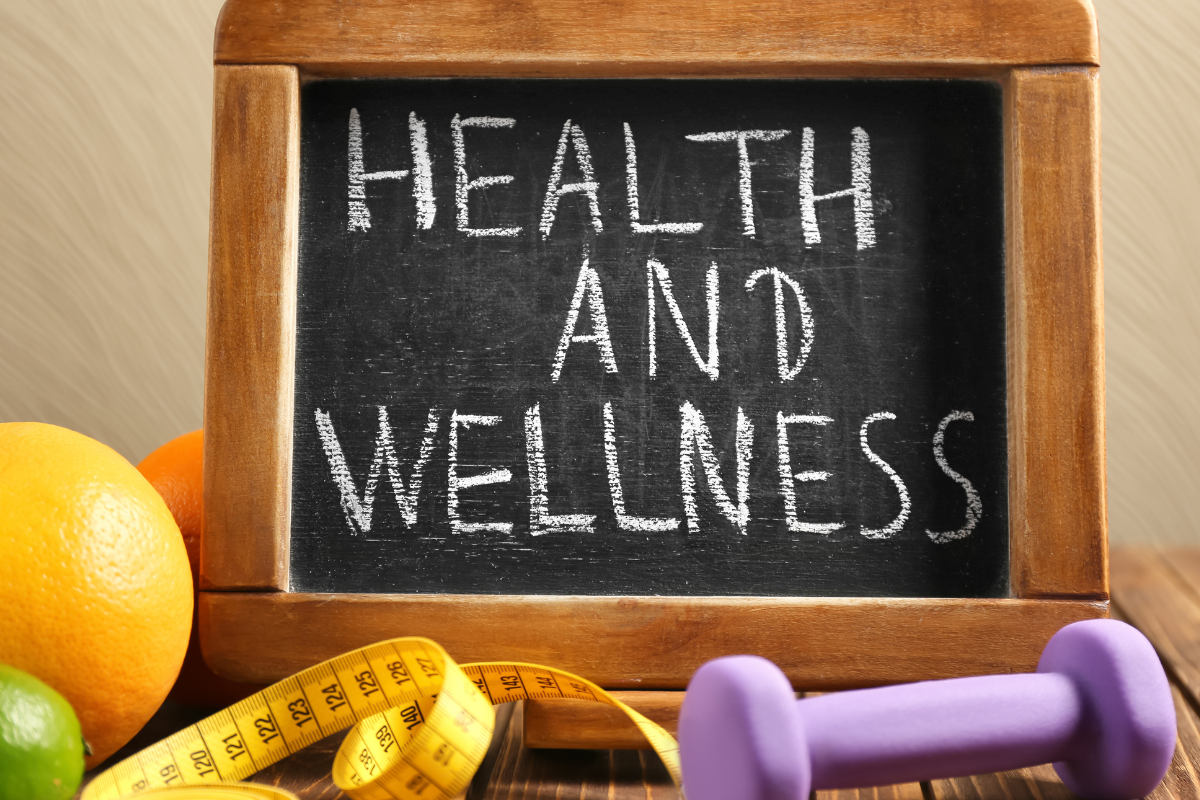 chalkboard with writing, a dumbell, tape measurer, and lemons 