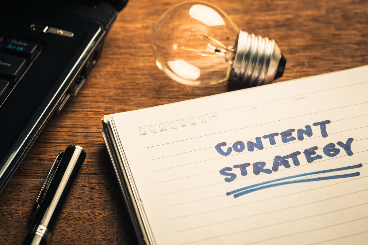 Notebook open with content strategy written on top