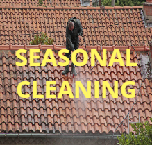 a man is cleaning a tiled roof with a high pressure washer MRI Roofing Roof Cleaning Melbourne