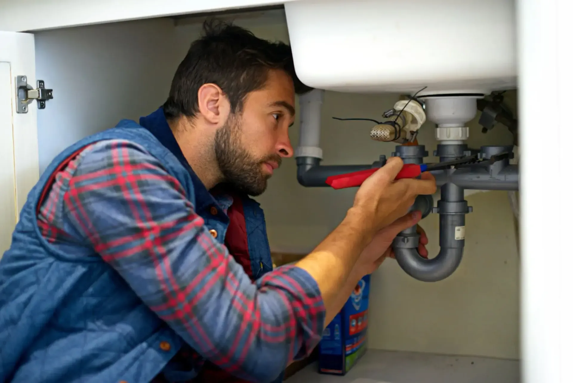 MasterCraft Plumbing plumber working on a kitchen sink in Jefferson, GA.