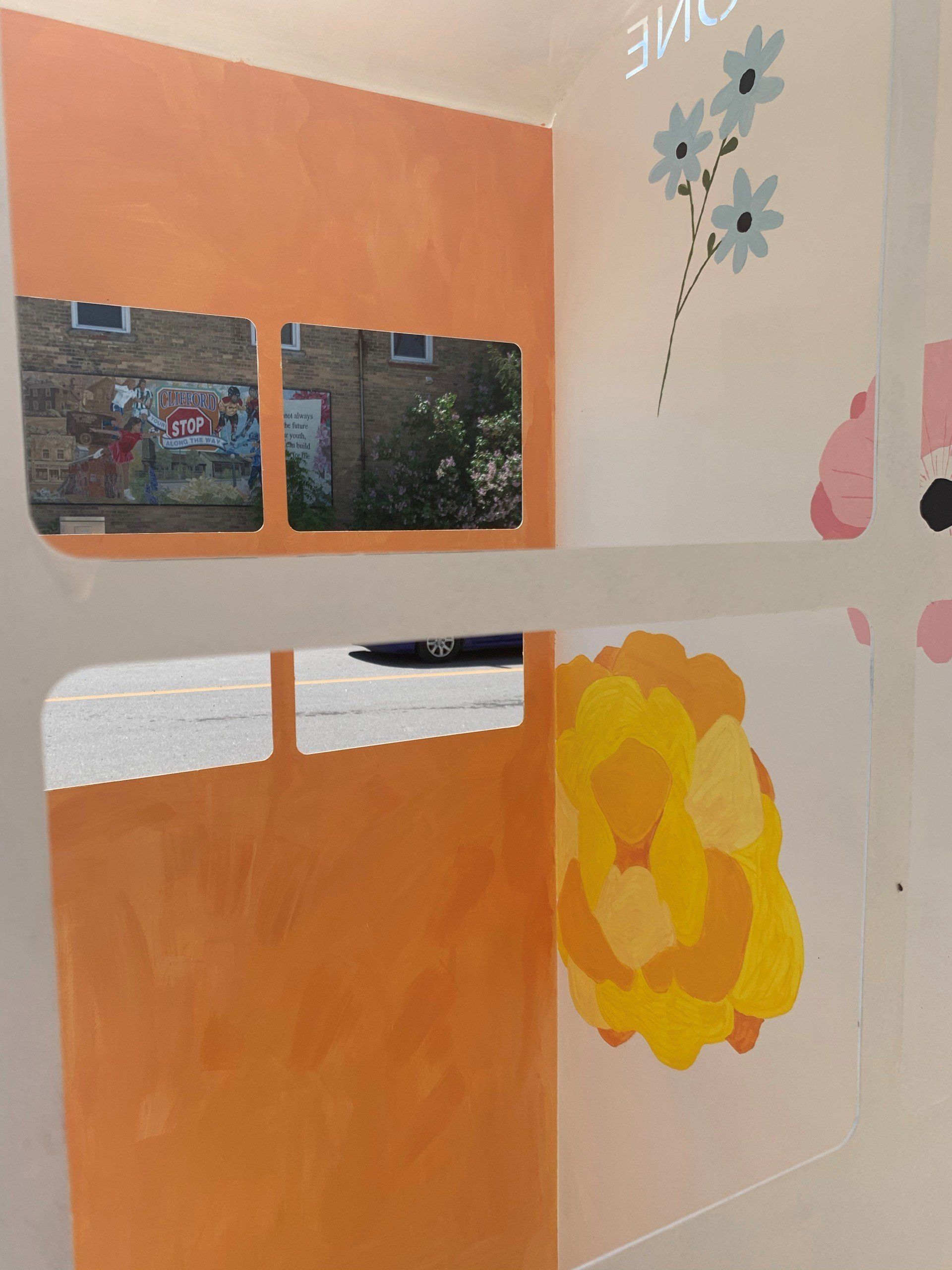 This booth was made for talking” mural – interactive art installation - orange and white with flowers