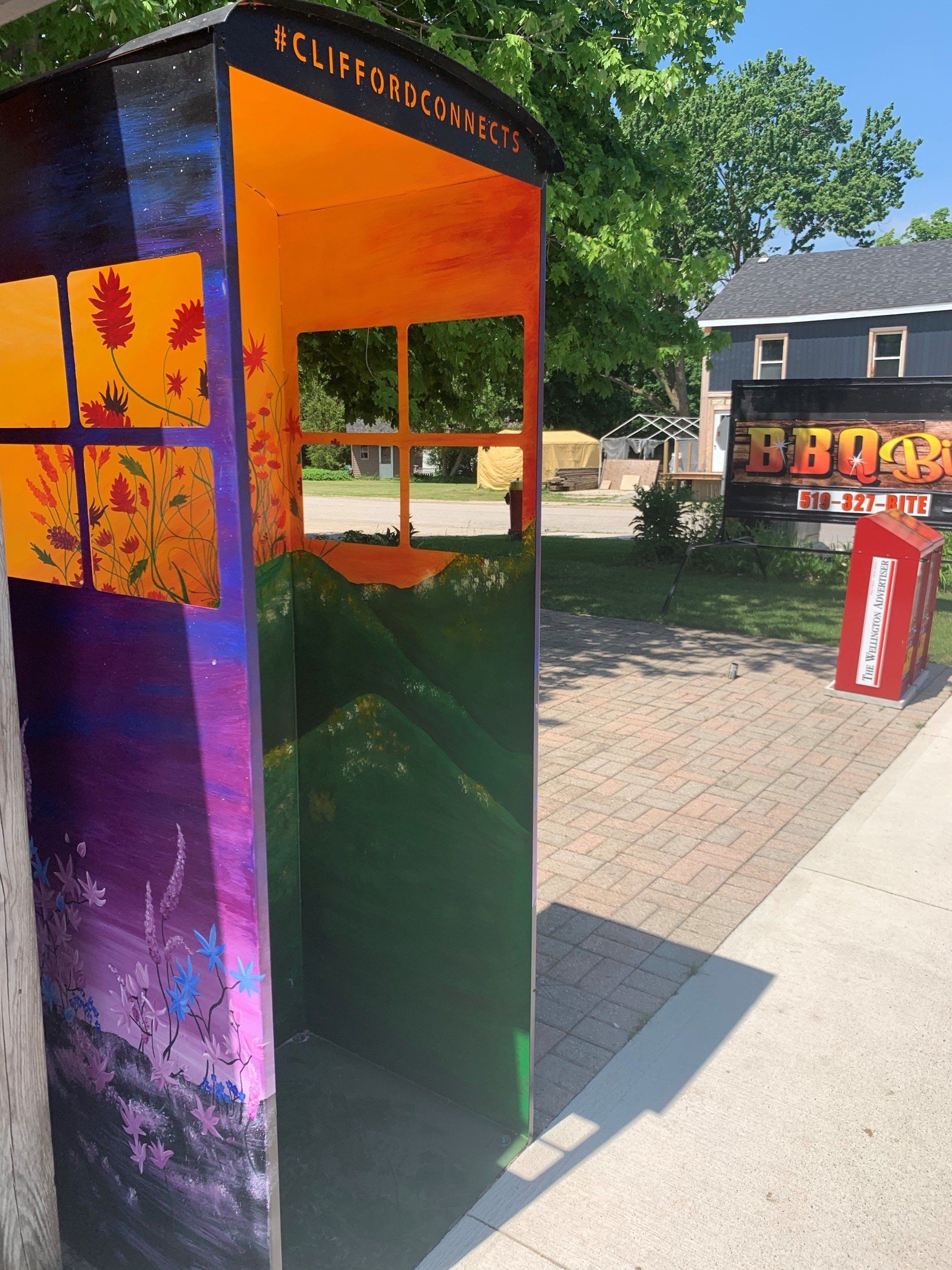 This booth was made for talking” mural – interactive art installation - orange flowers with puruple outside