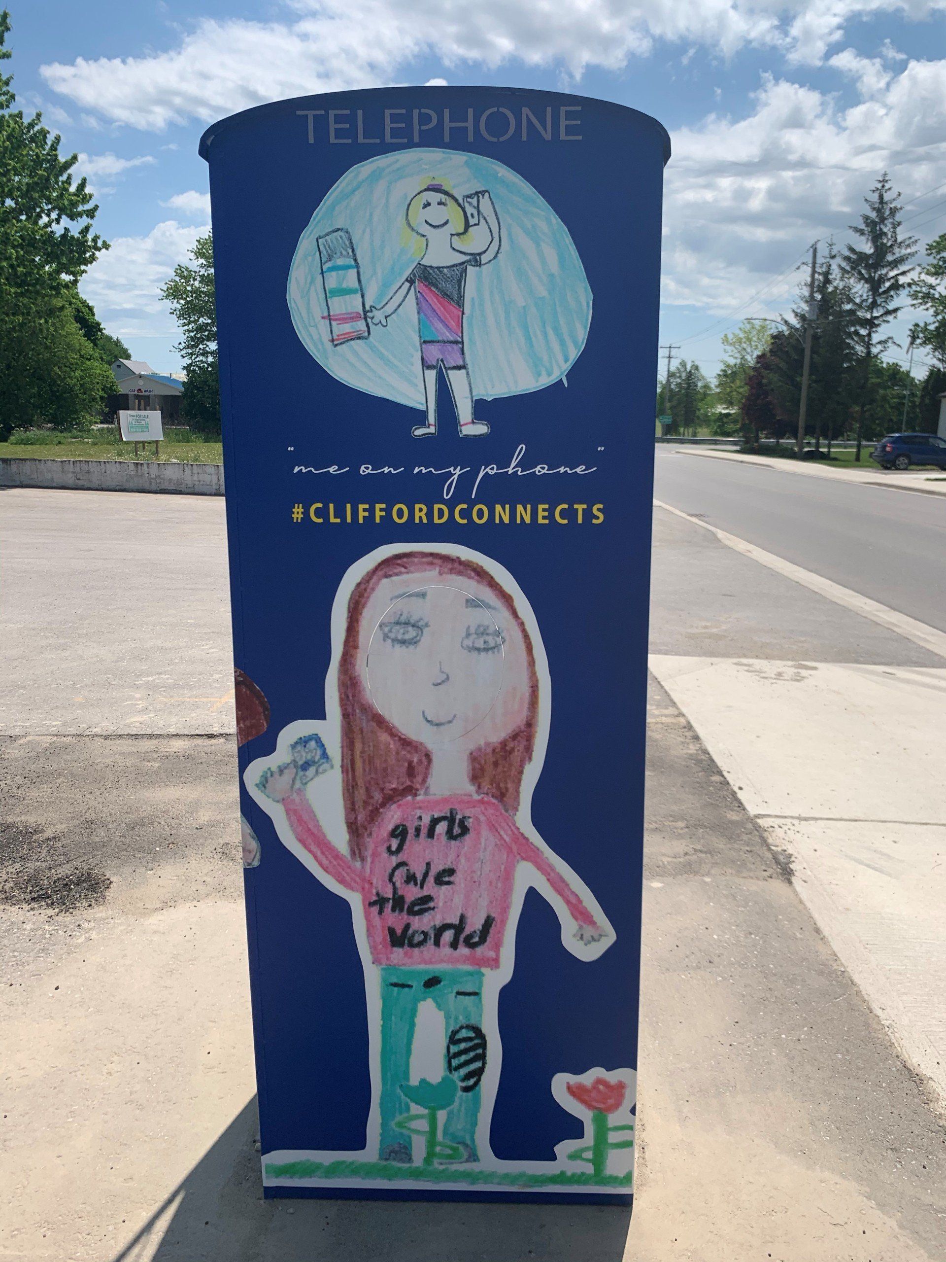 This booth was made for talking” mural – interactive art installation - blue booth  back with kids' art