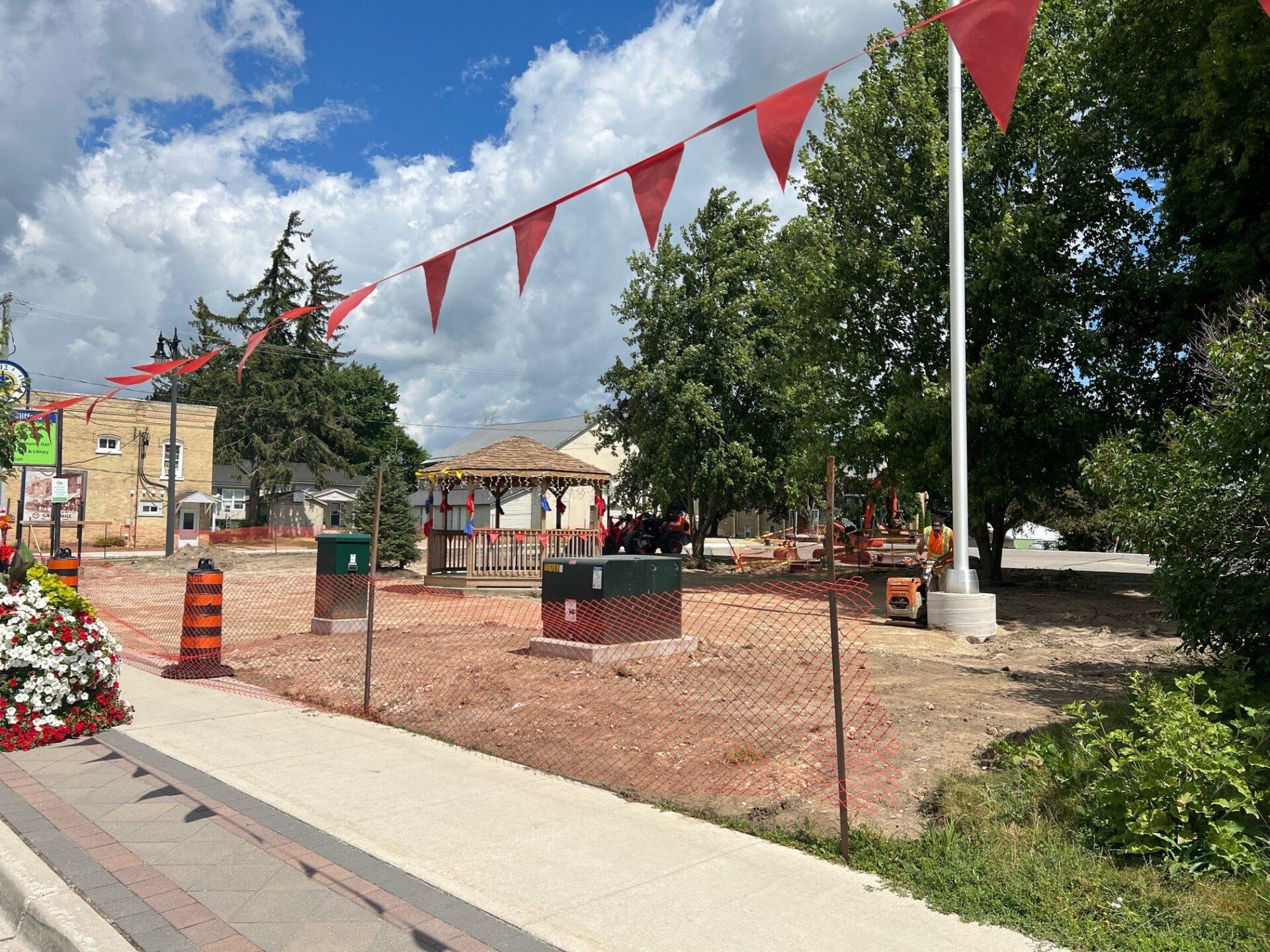 Construction progress at Clifford Rotary Celebration Square with red bunting and brickwork