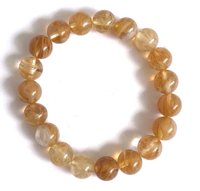 A bracelet with brown beads on a white background