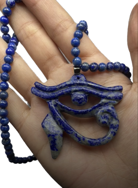 A close up of a necklace with a pendant on a mannequin.
