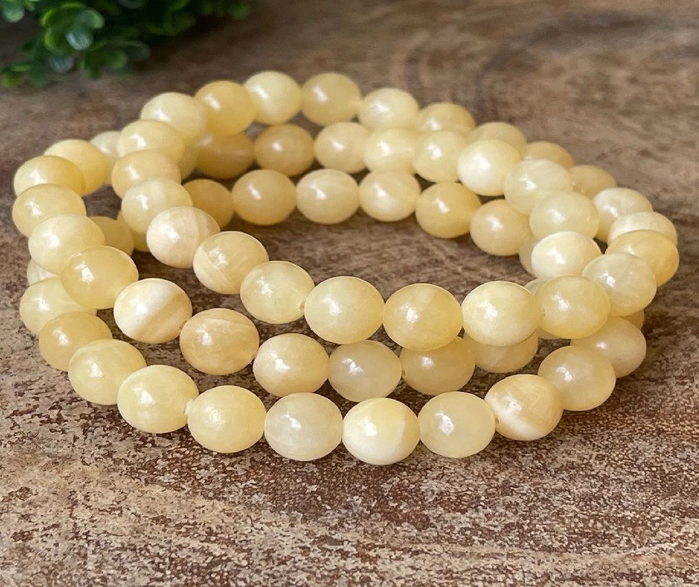 A person is wearing a yellow bracelet on their wrist.