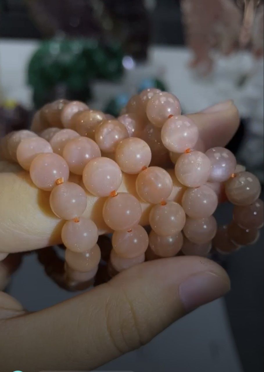 A person is holding a bunch of beads in their hand