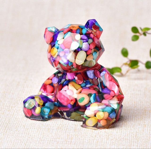 A colorful teddy bear is sitting on a table