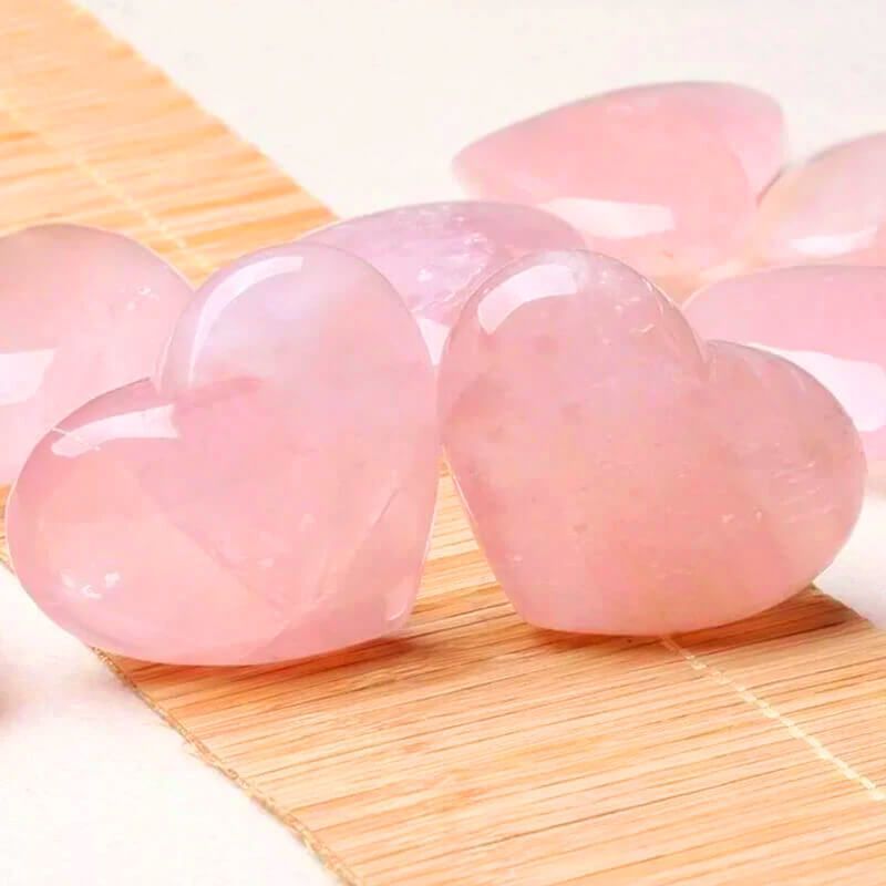 A group of pink hearts sitting on top of a bamboo mat.