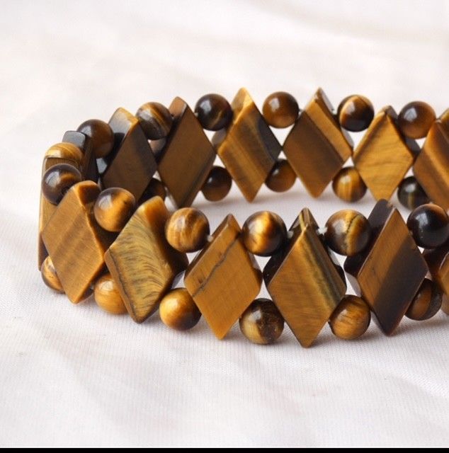 A bracelet made of tiger 's eye beads on a white surface