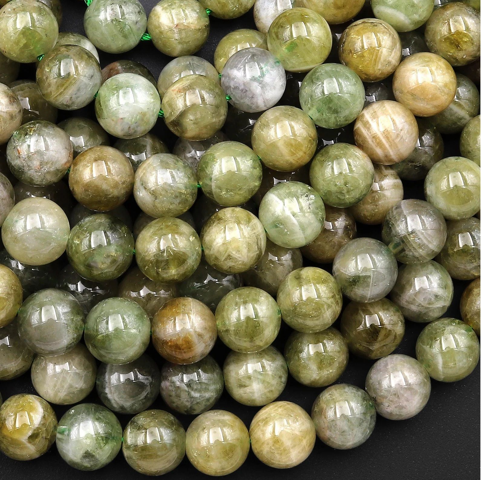 A person is holding a string of beads in their hand