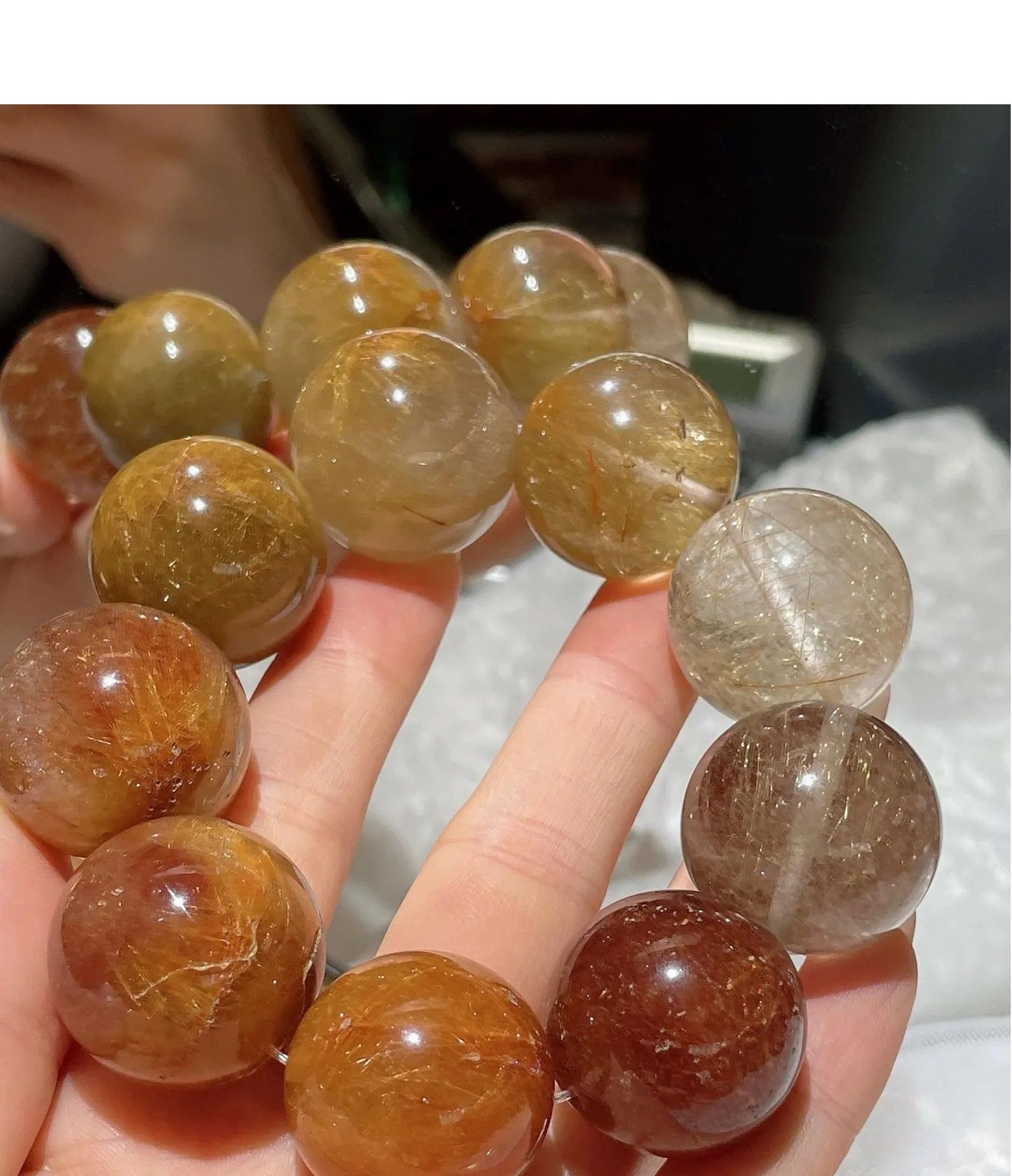 A person is holding a string of beads in their hands