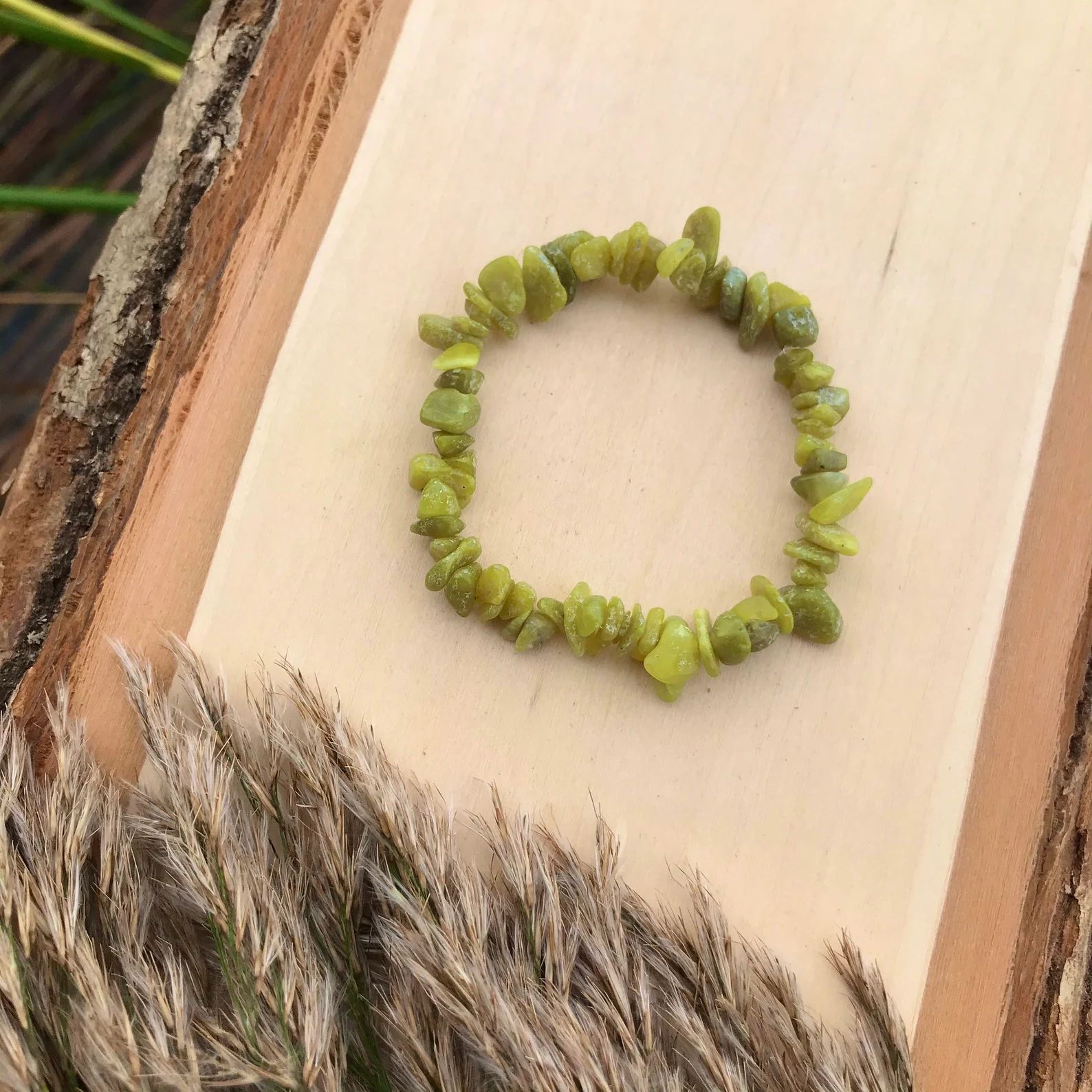 A bracelet made of small rocks on a white background
