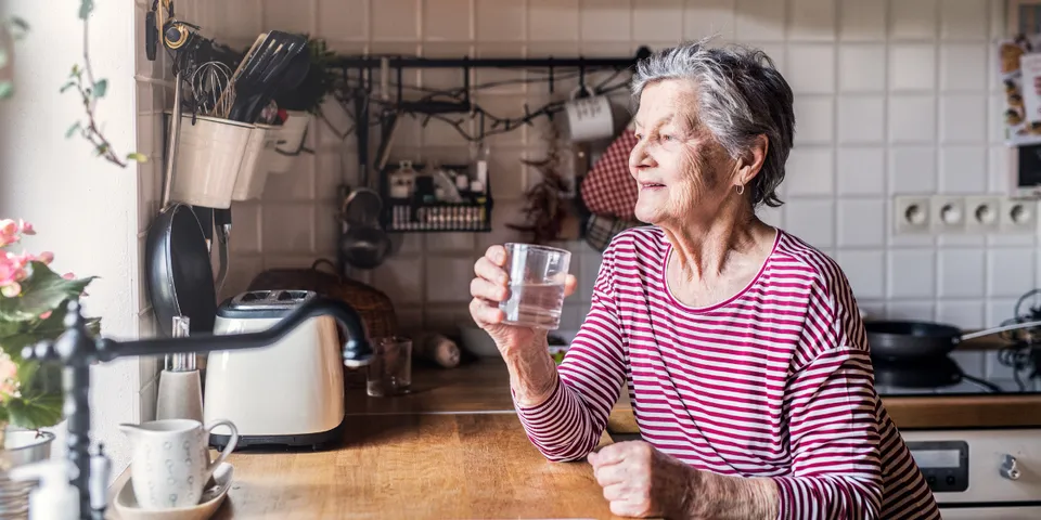 Old woman drinking water — Signal Mountain, TN — Trailhead Estate Planning